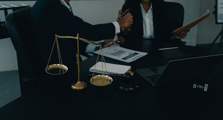Judge gavel with Justice lawyers having team meeting at law firm background. Concepts of Law and...