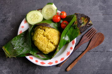 Nasi Kuning is Indonesian tradiotional yellow rice, made of turmeric, coconut milk, spices. 