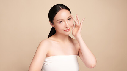 Beautiful young asian woman with clean fresh skin on beige background, Face care, Facial treatment, Cosmetology, beauty and spa, Asian women portrait.