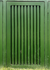 green metal door with vertical lines 