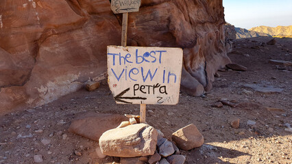 A rustic old sign post for the best view in Petra with an arrow in the popular tourism destination...