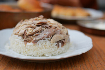 Boiled chicken, steamed rice, pink plate.