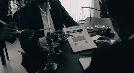 Judge gavel with Justice lawyers having team meeting at law firm background. Concepts of Law and...