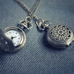 pocket watch on blue.Vintage watch pocket.two minutes to twelve on retro watch on black wood.