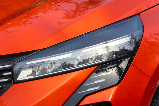 Exterior detail . close up of modern orange car xenon lamp headlight. © Виталий Сова