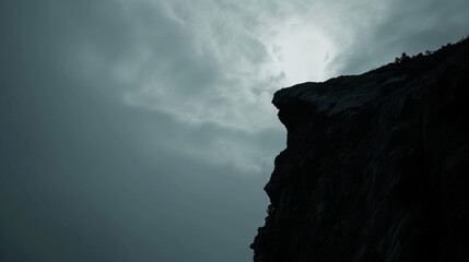 rock cliff edge stand alone against a cloudy sky mountain with gray sky