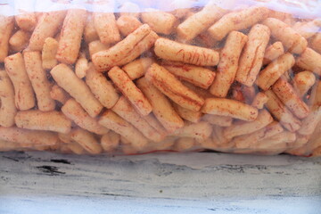 Indonesian snack called spicy crackers in plastic on the table