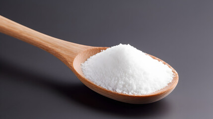 Fototapeta na wymiar white sugar on wooden spoon