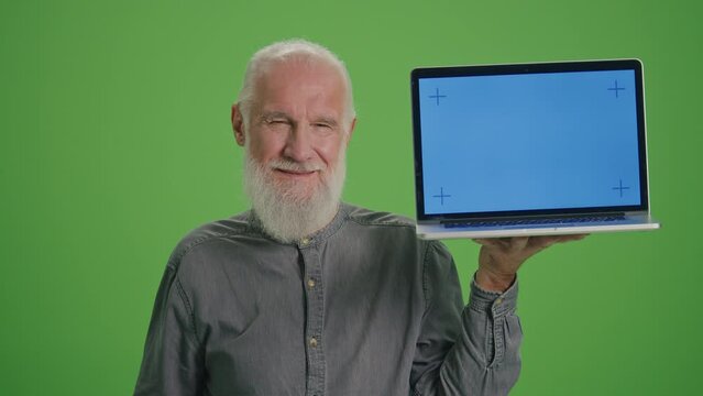 Green Screen.Portrait of an Old Man with a Laptop with Blue Screen Shows Thumb Up. Artificial Intelligence and Machine Learning for Seniors. Smart Homes and the Internet of Things for Seniors.