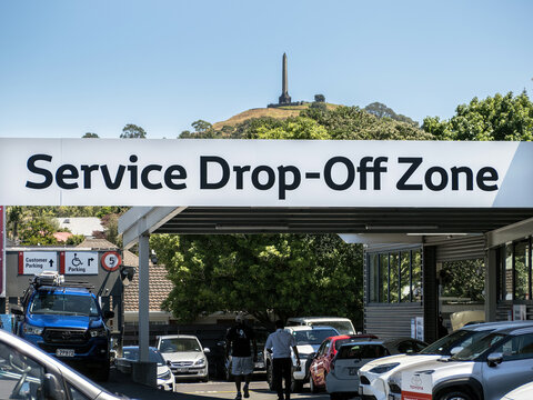 Service Drop-Off Zone sign at car dealership yard. Auckland, New Zealand - February 8, 2024