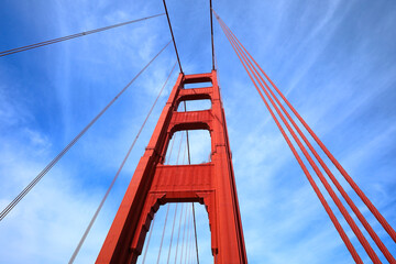 The Golden Gate Bridge: Looking up at the famous suspension bridge spanning the bay inlet in San...
