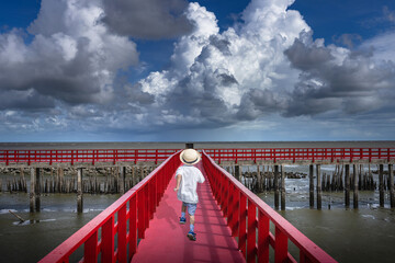 Behind asian boy Running at the red bridge Samut Sakhon Province, Thailand. - 732223991