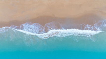 Fototapeta na wymiar The soft wave water of the sea on the sandy beach background