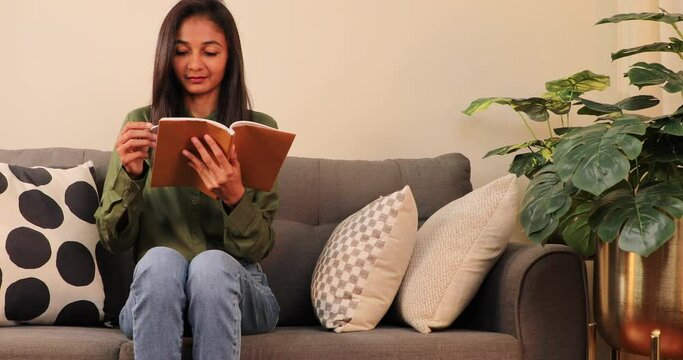 Beautiful young woman working on book.