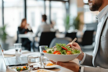 Businessman at working place with vegetable salad in bowl and fork in hand, diet and eating right...