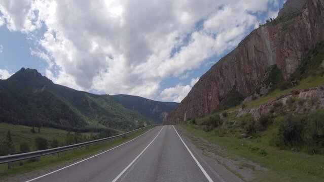 Driving in a car along the mountain road of the Chuya Highway or the Chuysky Trakt in Altai. Siberia, Russia