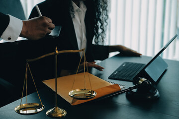 Judge gavel with Justice lawyers having team meeting at law firm background. Concepts of Law and...