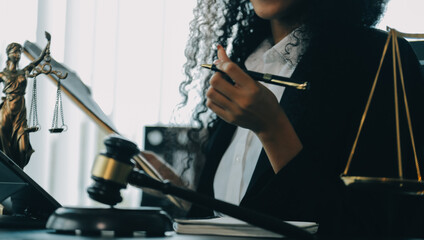 Judge gavel with Justice lawyers having team meeting at law firm background. Concepts of Law and...