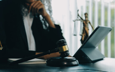 Judge gavel with Justice lawyers having team meeting at law firm background. Concepts of Law and Legal services.