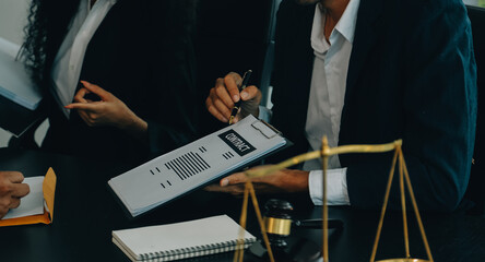 Judge gavel with Justice lawyers having team meeting at law firm background. Concepts of Law and Legal services.