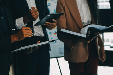 Business team meeting working with new startup project, discussion and analysis data the charts and graphs. Digital tablet, calculator, laptop computer using, Business finance and accounting concept.