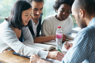Students, college and education, studying together with books for research project and diversity on university campus. Discussion, learning and knowledge for academic growth, with people and teamwork