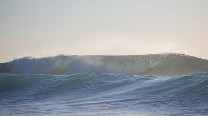 Breaking wave on the coastline in the morning.