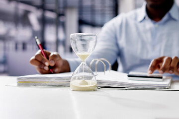 Hourglass And Time Crunch With Document