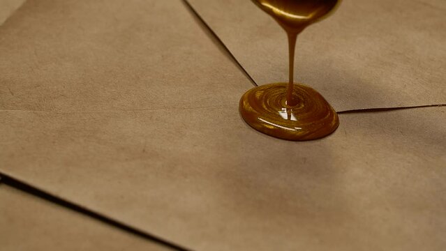 Golden vintage heart wax stamp sealing on brown postal envelope from craft paper