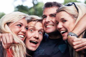 Face, smile and hug with excited friends closeup outdoor in nature together for travel, festival or adventure. Party, energy or wow with man and woman group laughing in forest or woods in summer - obrazy, fototapety, plakaty