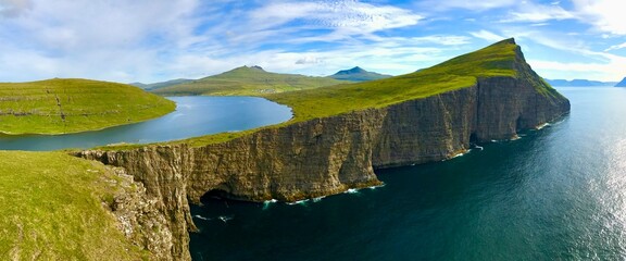 Landscape panorama Sorvagsvatn lake on cliffs of Vagar island, Faroe Islands, Denmark. Lake above the ocean. a lake on the edge of an abyss. Hiking and travel concept. © Iryna