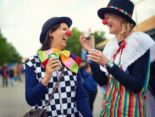 Clown, people and outdoor at festival, carnival or costume for event or concert in park. Happy,...