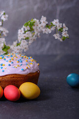 Freshly baked homemade Easter bread, natural dyed eggs and spring flowers.