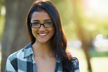 Woman, portrait and student outdoors on campus, eyewear and pride for education in nature. Female person, confidence and glasses for learning or enjoying park or garden, happy and positive outside