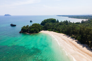 Islands coastline with azure waters, powdery white sand beaches, clear skies and shallow coral reefs.