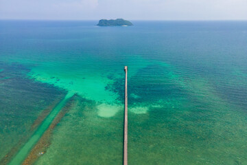 Bridge in the middle of the sea and island in the middle of the sea with blue sea water