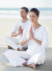 Couple, yoga and sea with meditation, zen and waves on sand in morning with mindfulness in summer. Man, woman and outdoor for namaste with spiritual growth, balance and peace at beach in Cape Town