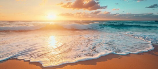 The sun softly sets, casting a golden hue on the water. Waves crash rhythmically upon the sandy shore, creating a soothing natural landscape.