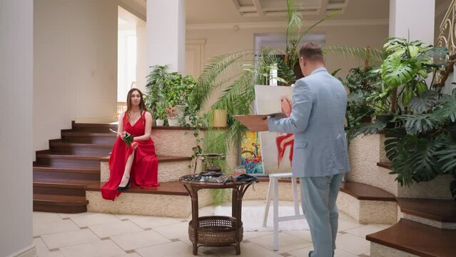 Artist sketches woman in red clothes in gallery