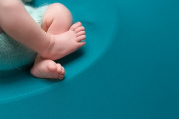 newborn baby feet on blue background