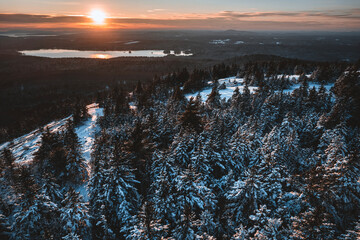 Aerial view sun setting over snow covered landscape, Bucksport, Maine