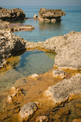 Fototapeta na wymiar Tide pools of sea water along the rocky shore of the island of Crete