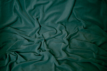 texture of a warm soft dark green synthetic fabric