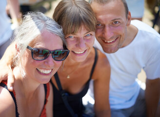 Portrait, people and happy friends at festival outdoor, bonding and having fun together at celebration in summer. Face, smile and group of mature women, man and party at carnival for social event