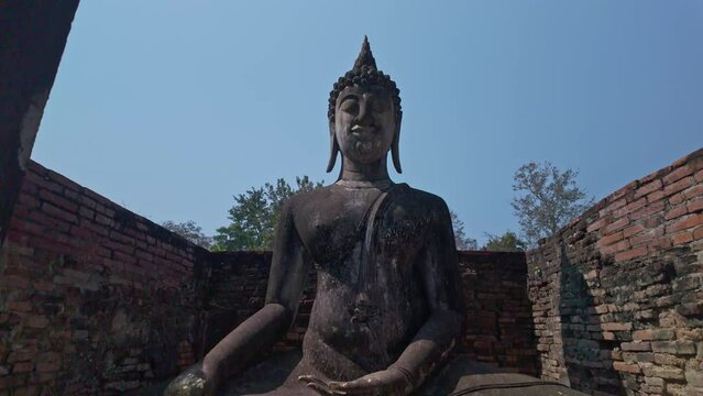 .Beautiful statue of Buddha and the ruins of buildings in historical sites built in the Sukhothai period in Wat Sri Chum, Sukhothai Province. .Phra Ajana, The beautiful Buddha statue in the  church. .