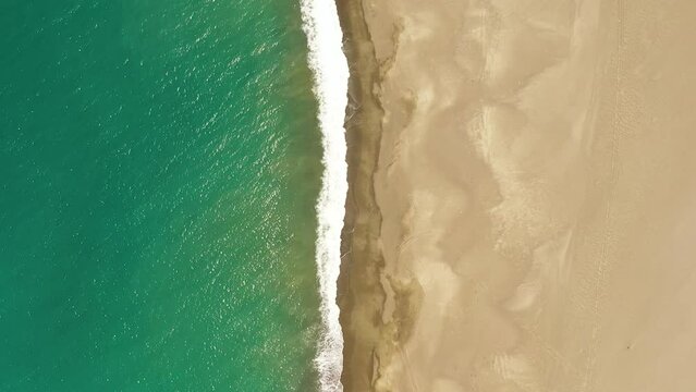 Top view of beautiful sandy beach and sea surf with waves. Philippines.
