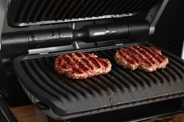 Beef cutlet for burger on grid grill