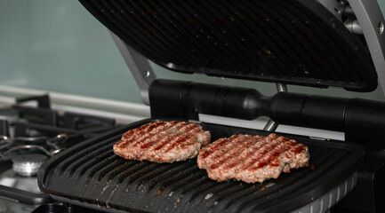 Beef cutlet for burger on grid grill