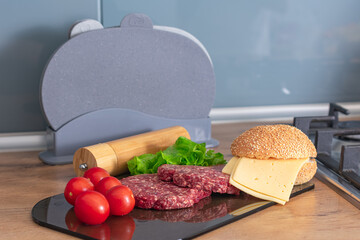 Beef cutlet for burger, tomatoes, cheese and lettuce. Burger ingredients