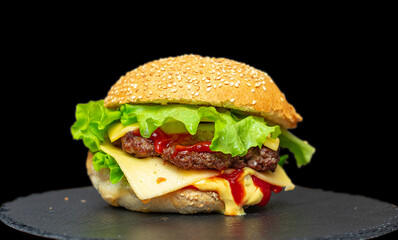fresh tasty burger on black background